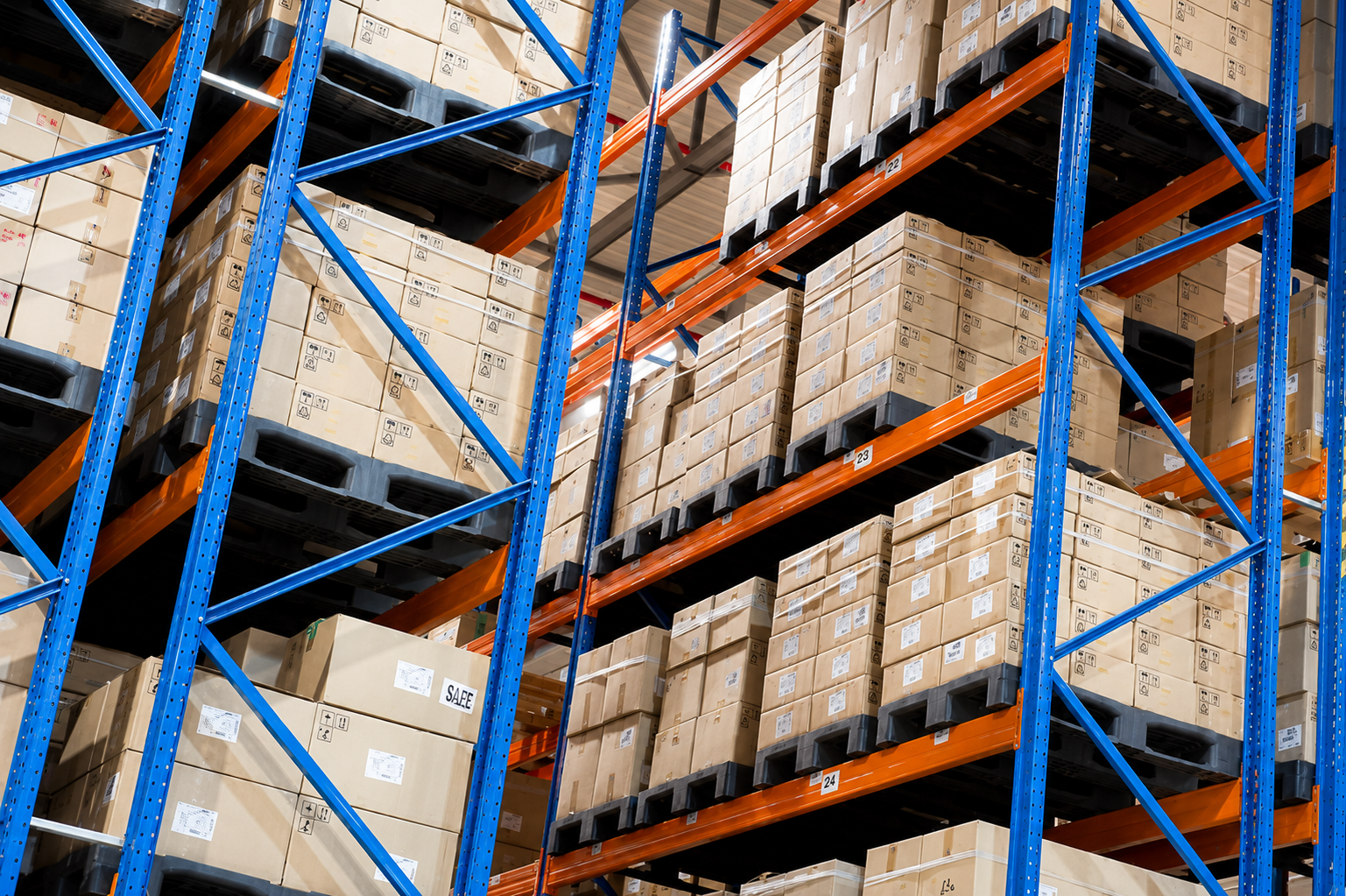 Diferentes tipos de tarimas industriales almacenadas en racks selectivos de centro de distribucion